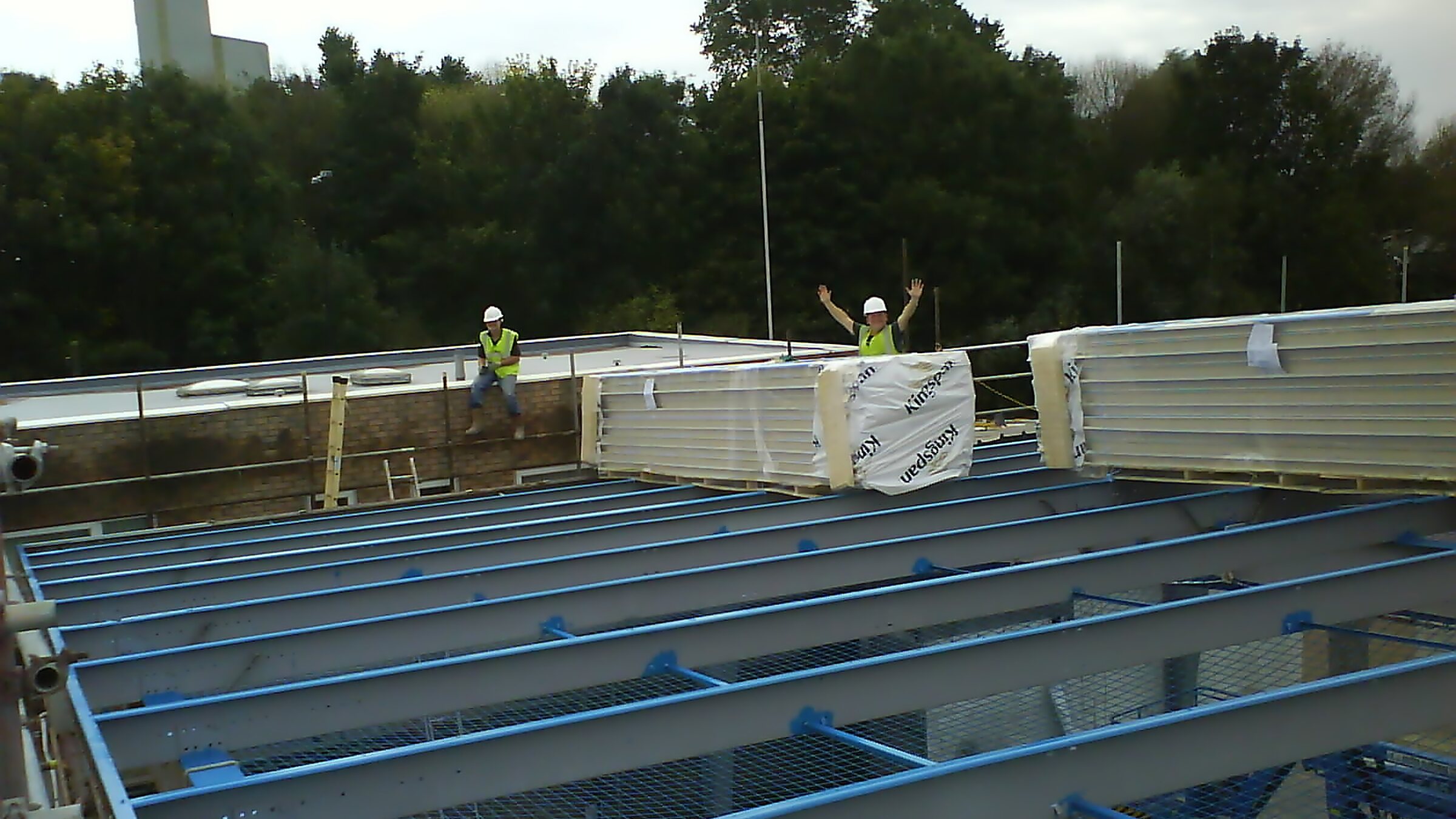P.A.J. Industrial Roofing team fixing Kingspan panels onto a steel roof frame