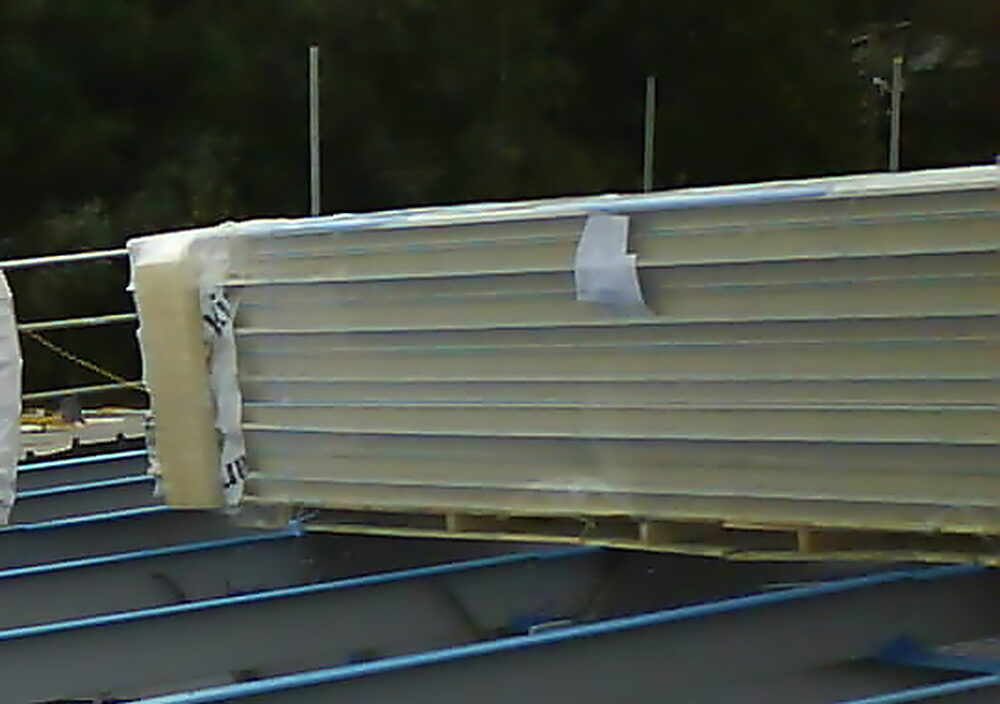 Kingspan insulated roof panels stacked on site, ready to fix