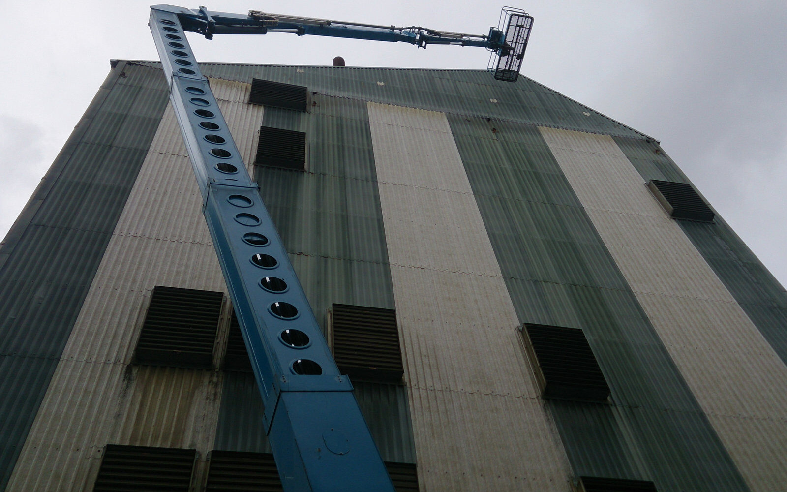 Cladding a tall industrial building from a cherry picker